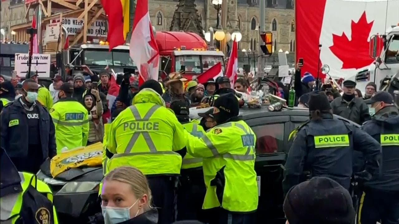 Watch: truckers in Canada hold ground despite threats of crackdown