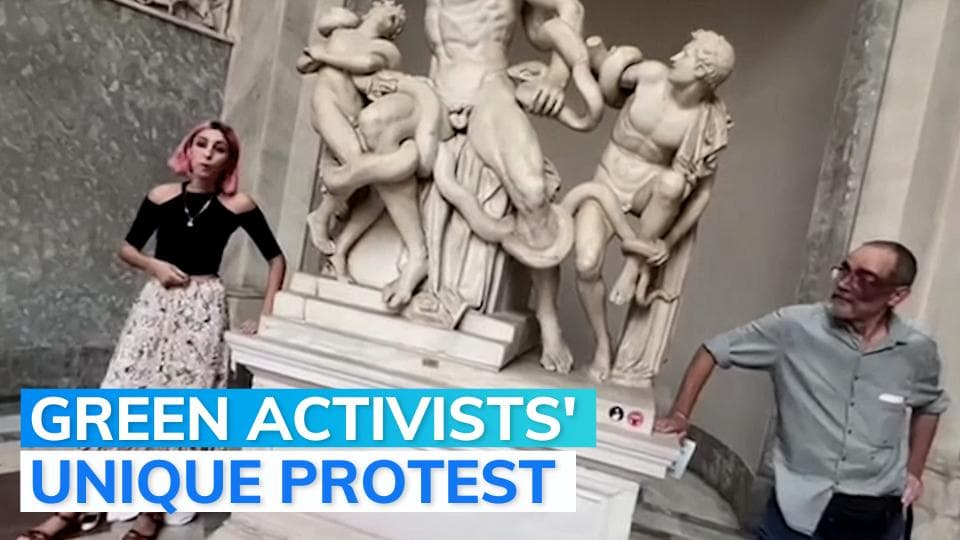 Climate activists glue their hands to a statue in Vatican Museum