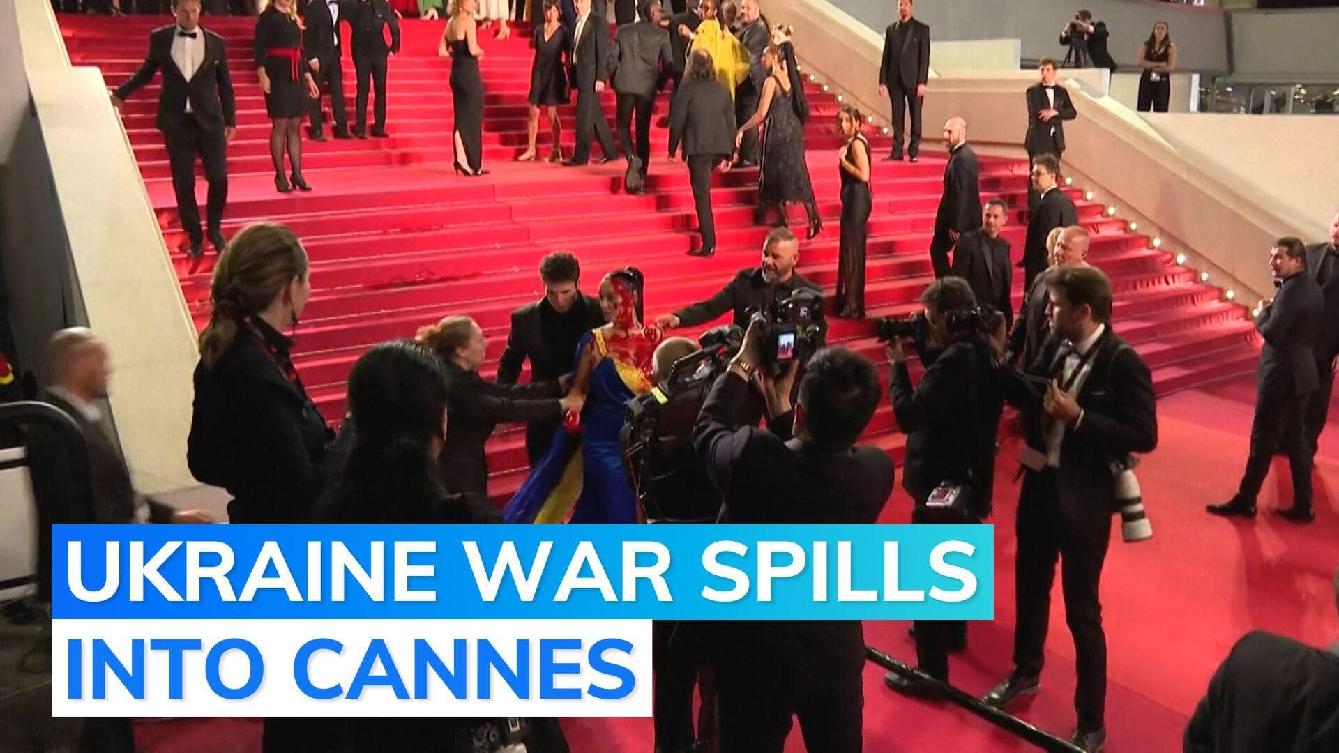 Cannes 2023: woman wearing Ukrainian colours pours 'fake blood' on herself