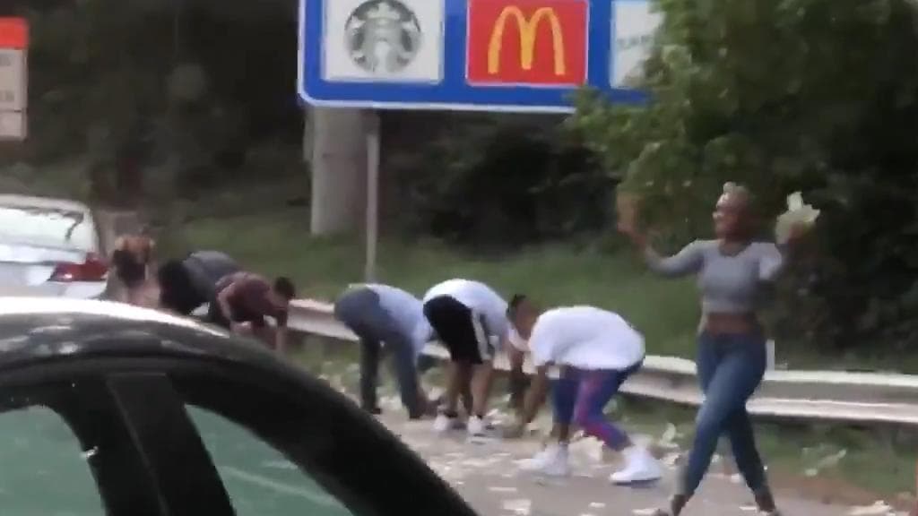 Watch: U.S. travellers scramble for dollars after money falls out of armoured truck