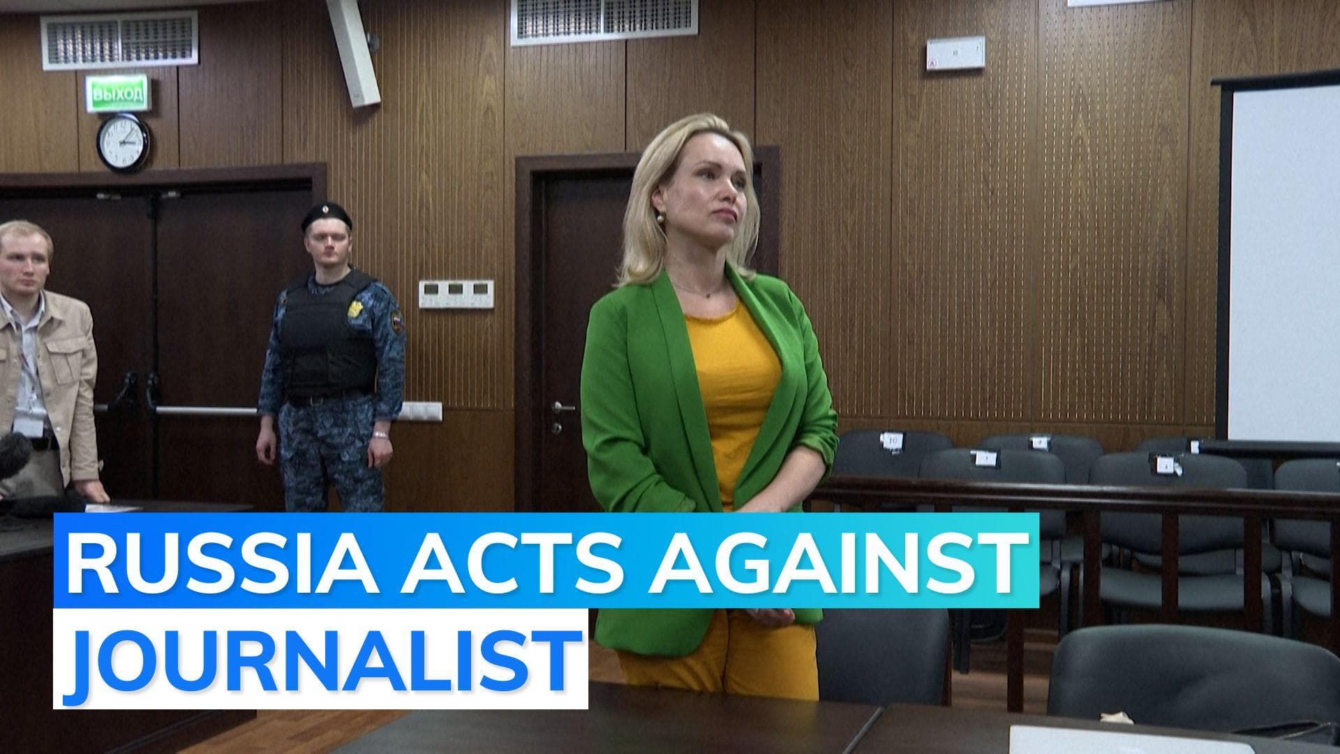 Russia targets reporter with raid, probe over 'anti Putin' protest